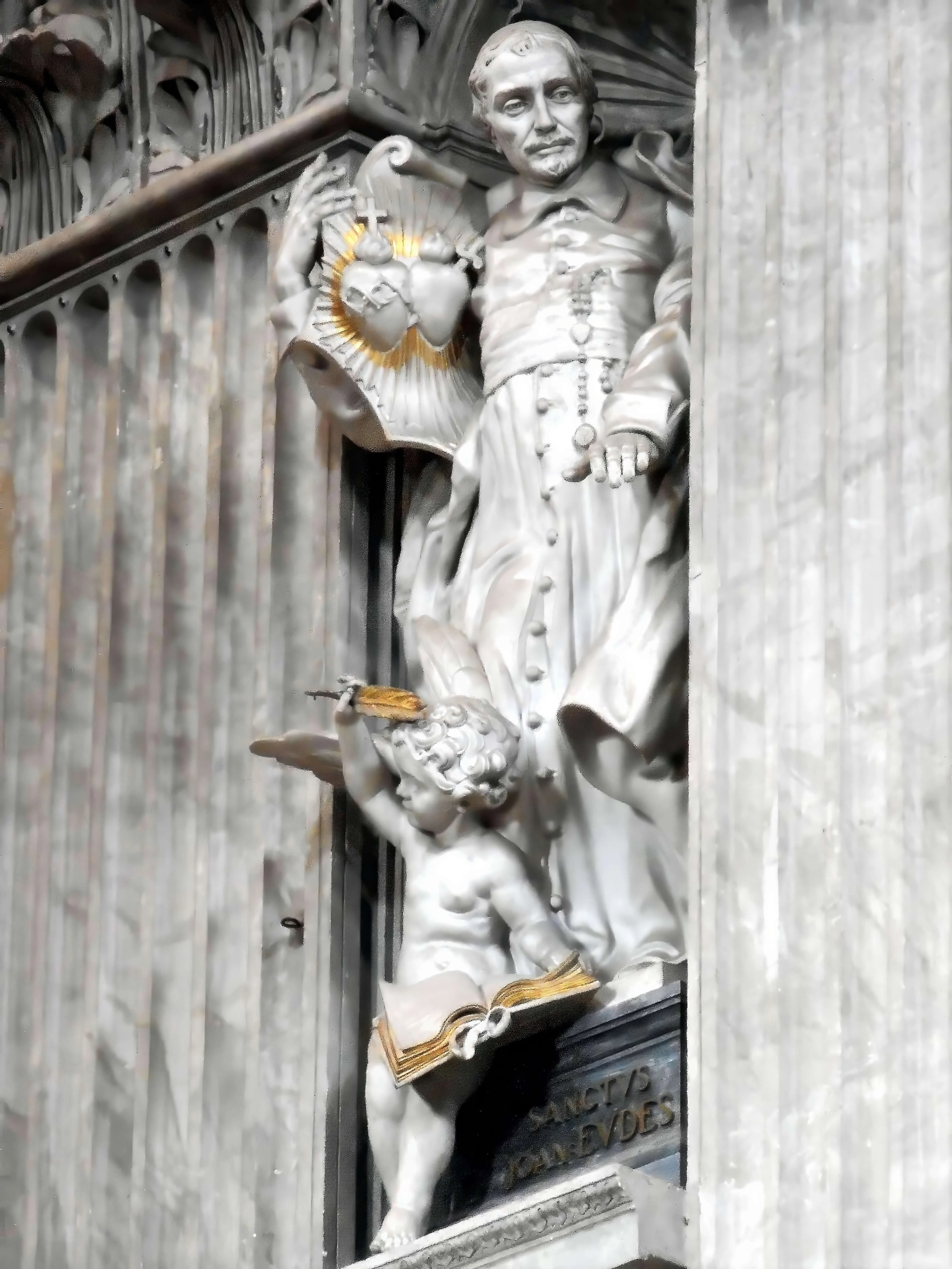 Statue of Saint John Eudes holding the Hearts of Jesus and Mary